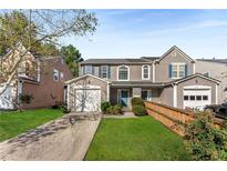 Charming townhome with attached garage, manicured lawn and tidy landscaping at 5845 Hampton Ct, Atlanta, GA 30349