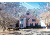 Brick two-story home with a large front yard and mature trees at 1325 Starboard Way, Cumming, GA 30041
