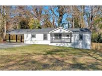 Newly renovated house with a modern exterior and a spacious yard at 1766 Blossom Ln, Austell, GA 30168