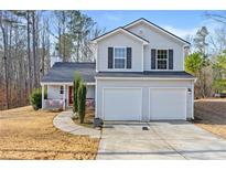 Charming two-story home featuring a two-car garage and inviting front porch at 125 Gum Creek Lndg, Oxford, GA 30054