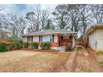 Brick ranch home with a well-maintained lawn at 1881 Broad Ave, East Point, GA 30344