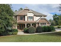 Beautiful two-story home with a stone and siding exterior, lovely landscaping and a welcoming front porch at 5669 Hollowbrooke Nw Ln, Acworth, GA 30101