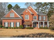 Brick two-story house with a large front yard and landscaping at 5114 Parkwood Oaks Ln, Mableton, GA 30126