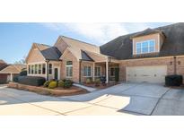 Brick front exterior with two-car garage and landscaping at 316 Brookhaven Walk # 1404, Johns Creek, GA 30097