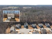 An aerial view of a gray two story home nestled in a cul-de-sac surrounded by mature trees at 4770 Alford Commons, Cumming, GA 30028