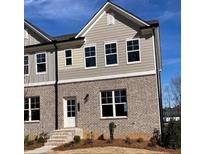 Two-story townhome with brick and siding, featuring multiple windows and a front entry at 1250 Ainsworth Aly # 42, Sugar Hill, GA 30518