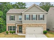 Charming two-story home with brick and siding, features a well-maintained lawn and attached garage at 821 Ethereow Ct, Lawrenceville, GA 30046