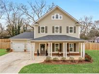 Charming two-story home features a welcoming front porch and well-maintained landscaping at 3 Derrick Ave, Hampton, GA 30228