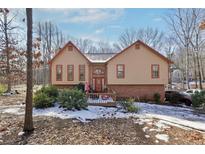 Two-story house with brick and siding exterior, deck, and landscaping at 6851 Alexander Pkwy, Douglasville, GA 30135