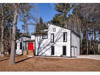 Modern house exterior with red door, surrounded by trees at 2645 Shadow Woods Ne Cir, Marietta, GA 30062