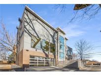 Modern home with brick and gray siding, glass garage door, and fenced yard at 426 Arnold Ne St, Atlanta, GA 30308