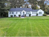 White brick ranch house with gray shutters, spacious lawn, and a long driveway at 1641 Pinehurst Sw Dr, Atlanta, GA 30311