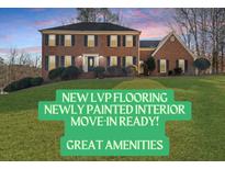 Charming two-story brick home featuring a well-maintained lawn, traditional shutters, and an inviting entryway at 5659 Brookstone Nw Dr, Acworth, GA 30101