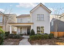 Two-story house with light gray siding, front porch, and landscaping at 3216 Colchester St, Douglasville, GA 30135