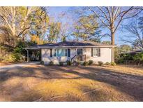 Brick ranch home with carport and landscaped yard at 2196 Knoll Dr, Decatur, GA 30032