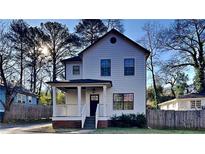 Charming two-story house with a front porch and landscaped lawn at 2548 Bellview Nw Ave, Atlanta, GA 30318