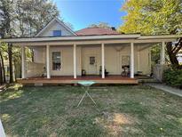 Charming white house with a large front porch and well-maintained lawn at 1090 Forest Ave, Stone Mountain, GA 30083