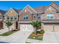 Brick front exterior of townhome with 2-car garage at 1216 Foxcroft Ln, Cumming, GA 30041