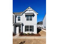 Two-story townhome with gray siding, black shutters, and landscaping at 1814 Emory Ln # 92, Conyers, GA 30013