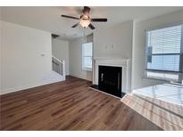 Bright living room featuring hardwood floors, fireplace, and large windows at 1814 Emory Ln # 92, Conyers, GA 30013