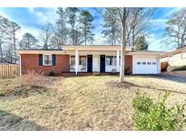 Brick ranch house with covered porch and attached garage at 3880 Admiral Dr, Atlanta, GA 30341
