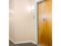 Apartment entry with wood door and neutral walls at 898 Oak St # 3311, Atlanta, GA 30310