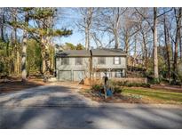 Two-story house with a driveway and landscaped yard at 257 Rock Garden Nw Ter, Marietta, GA 30064