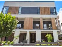 Modern three-story home with wood and white exterior, private balconies, and landscaping at 617 East Ave, Atlanta, GA 30312