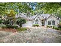 Beautiful home with a large driveway and mature landscaping at 110 Golf Terrace Dr, Stockbridge, GA 30281