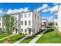 White brick townhome with gray roof and walkway at 3525 Grey St, Duluth, GA 30096