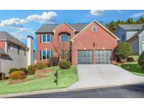 Brick two-story house with two-car garage and landscaped lawn at 3377 Hunters Point Se Rd, Smyrna, GA 30082