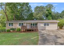 Ranch style home with a large deck and spacious yard at 4761 Lincoln Ne Dr, Kennesaw, GA 30144