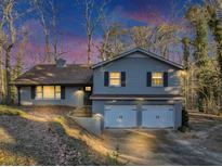 Gray house with a two-car garage and landscaping at 2545 Kingswood Dr, Marietta, GA 30066