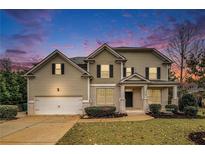 Two-story house with a large front yard and attached garage at 308 Evening Rain Crst, Canton, GA 30114