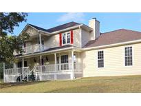 Two-story house with wrap-around porch and red shutters at 4335 Commodore Rd, Powder Springs, GA 30127