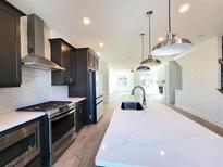 Modern kitchen with stainless steel appliances and a large island at 4802 Larkin Pass, Buford, GA 30518