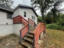 Gray house exterior with red stairs and wooden railings at 2308 Lakewood Sw Ave, Atlanta, GA 30315