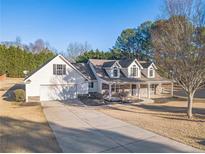 Single-story house with stone accents and a two-car garage at 910 Callee Dr, Loganville, GA 30052