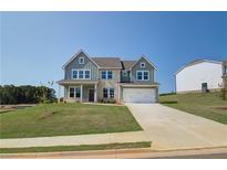 Two-story house with gray siding, stone accents, and a two-car garage at 151 Buffalo Trce, Stockbridge, GA 30281