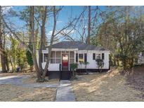 Charming white house with a screened porch and landscaped yard at 2178 Baker Nw Ter, Atlanta, GA 30318