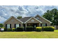 Brick house with a landscaped lawn and a two-car garage at 406 Trinkle Ct, Stockbridge, GA 30281