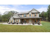 Two-story house with gray siding, brown accents, and a large front yard at 2647 Old Snapping Shoals Rd, Mcdonough, GA 30252
