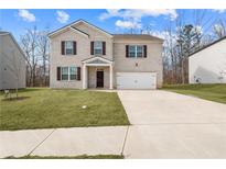 Two-story house with brick facade and a two-car garage at 2732 Piper Dr, Atlanta, GA 30331