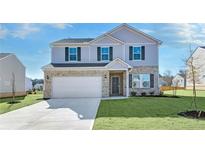 Two-story house with gray siding, brick accents, and a two-car garage at 513 Elkwood Ln, Mcdonough, GA 30252