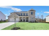 Beautiful two-story brick home with a well-manicured lawn and a welcoming covered front porch at 124 Aj Welch Jr Way, Mcdonough, GA 30252