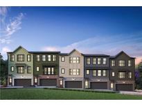 Modern townhouses with varying exterior colors and attached garages at 425 Firefly Cir # 42, Alpharetta, GA 30009