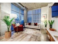 Modern living room features a comfy sofa, large windows, and stylish decor at 250 Pharr Ne Rd # 602, Atlanta, GA 30305