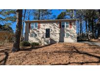 Tan two-story house with red shutters and a small yard at 2531 Ridgecrest Nw Dr, Kennesaw, GA 30152