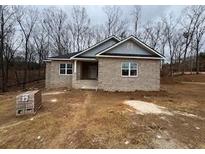 New construction home with brick exterior and a large front yard at 3383 Milan Ct, Douglasville, GA 30135