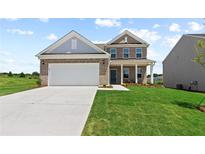 Two-story brick home with a large driveway and landscaped lawn at 316 Foxglove Way, Mcdonough, GA 30253